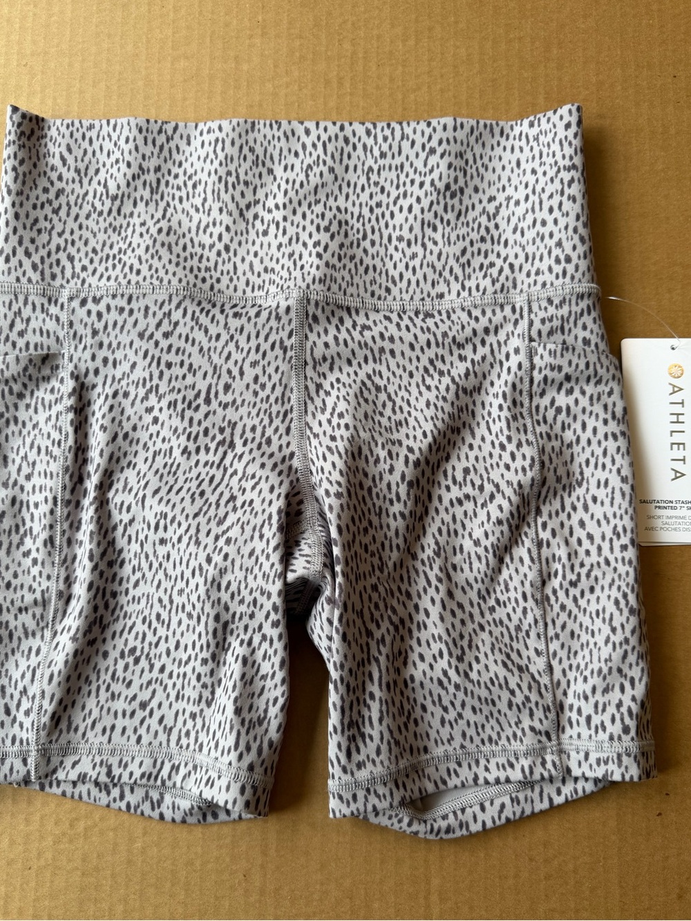 Athleta Salutation Stash Pocket shorts w/ neutral-toned leopard print